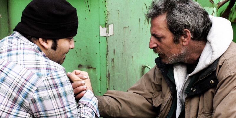 Homelessness worker with man on street