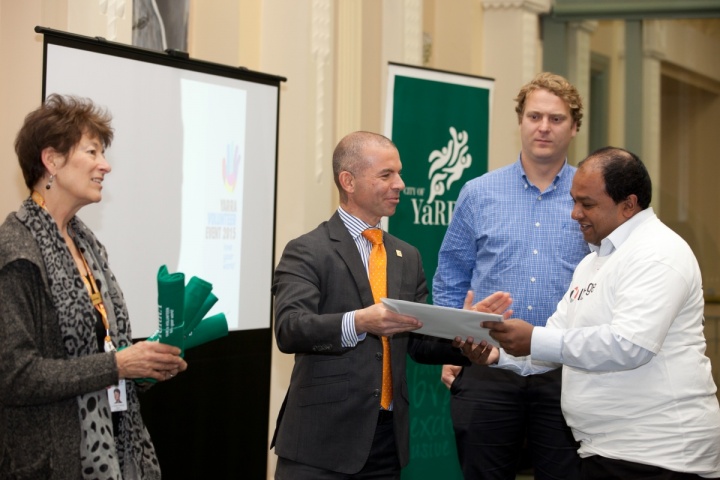 Volunteer Dinesh Jayasuriya receives a certificate.