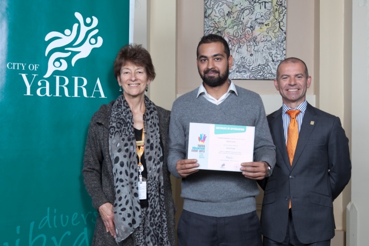 Cr Jackie Fristacky and Mayor Cr Phillip Vlahogiannis present volunteer Malik Umer with a certificate. 