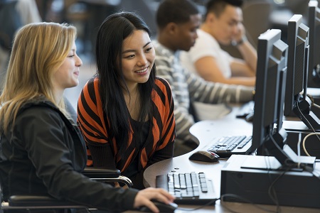 Photo of young people working at a computer