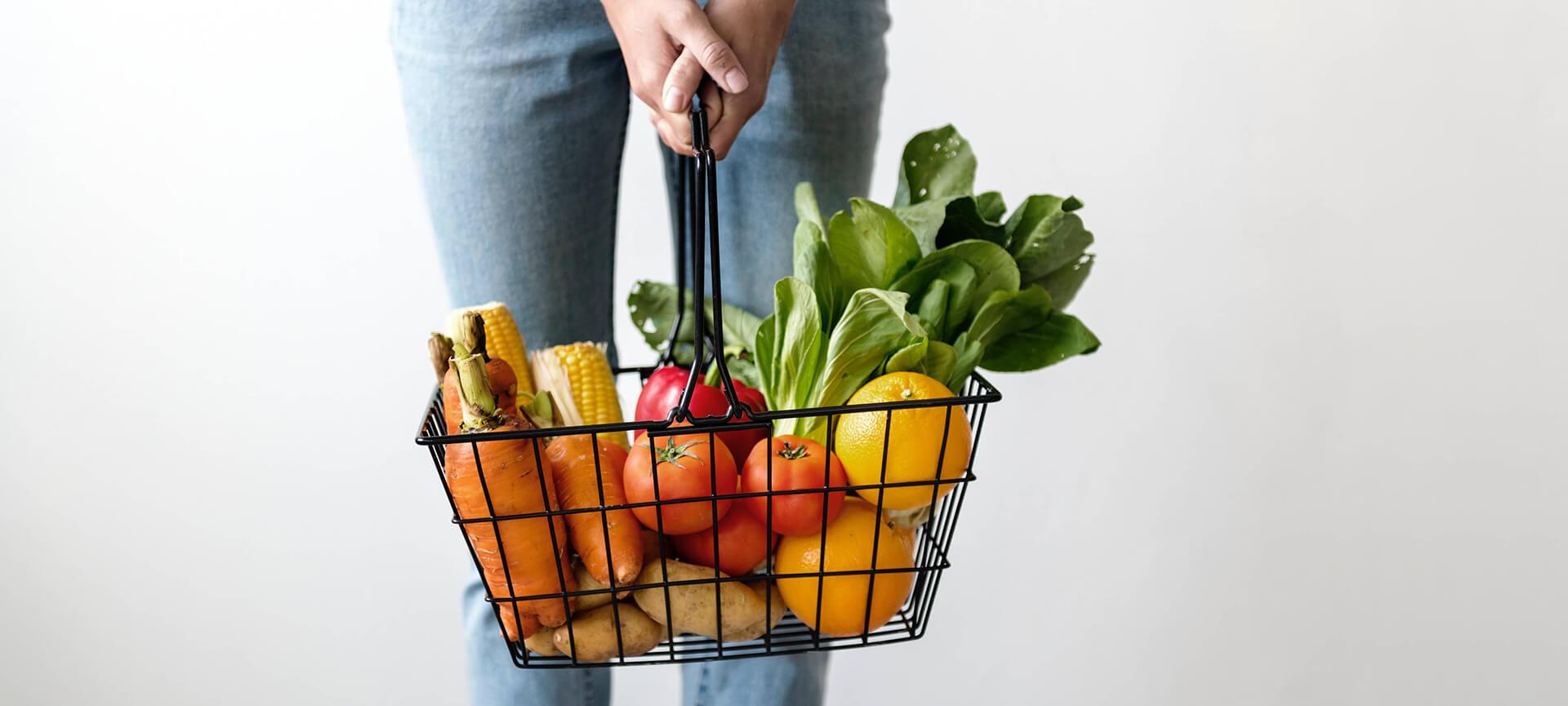 Woman holding basket of groceries