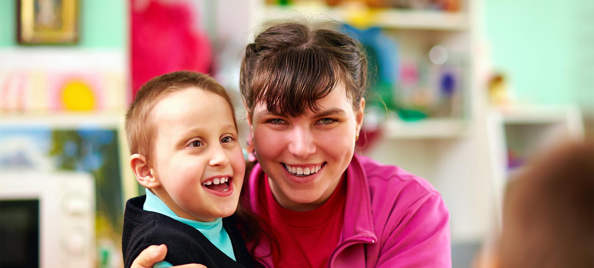 Boy with disability and girl smiling