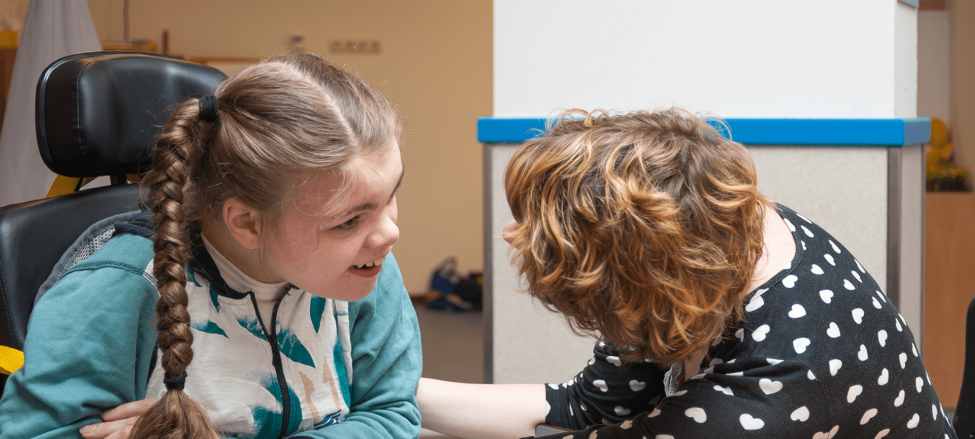 Girl in wheelchair with support worker