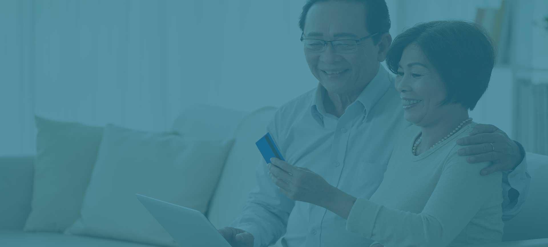 two older people using laptop for online banking