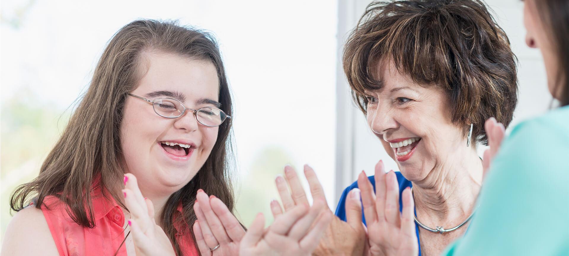 Down syndrome girl and woman smiling