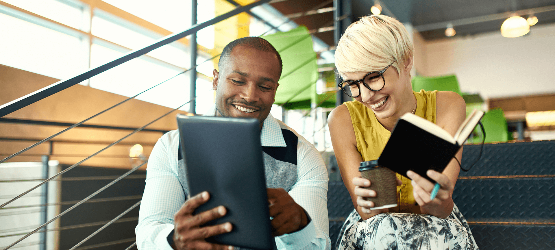 Two young workers looking at a tablet