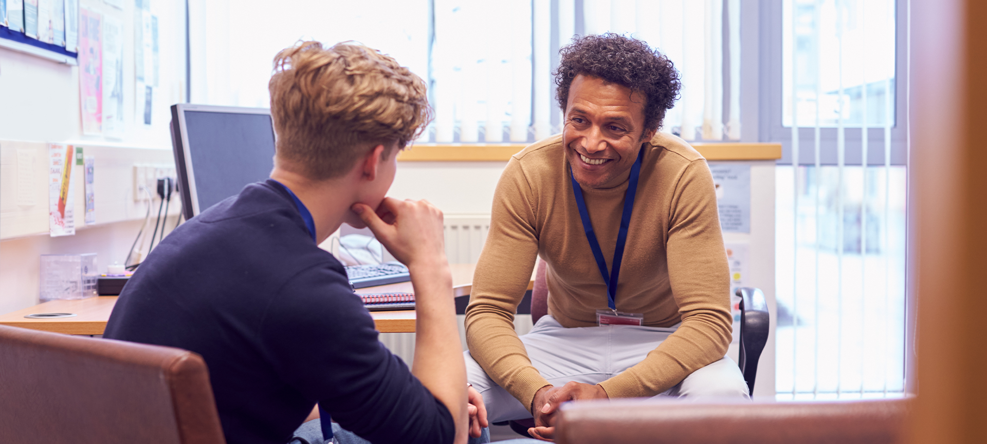 School counsellor speaking to student in an office