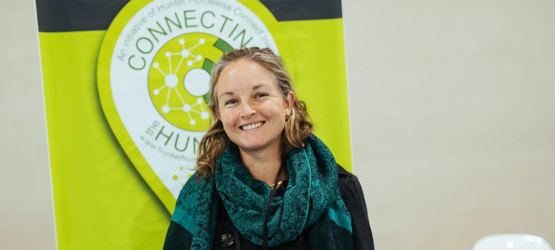 Nissa Phillips standing in front of bright green signage