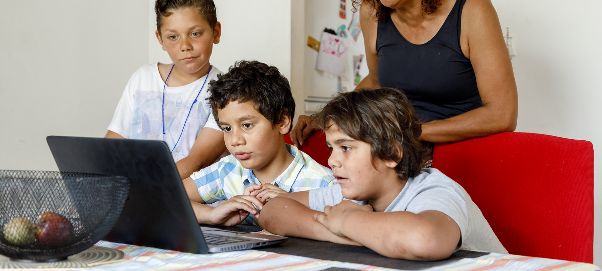 Aboriginal kids looking at laptop