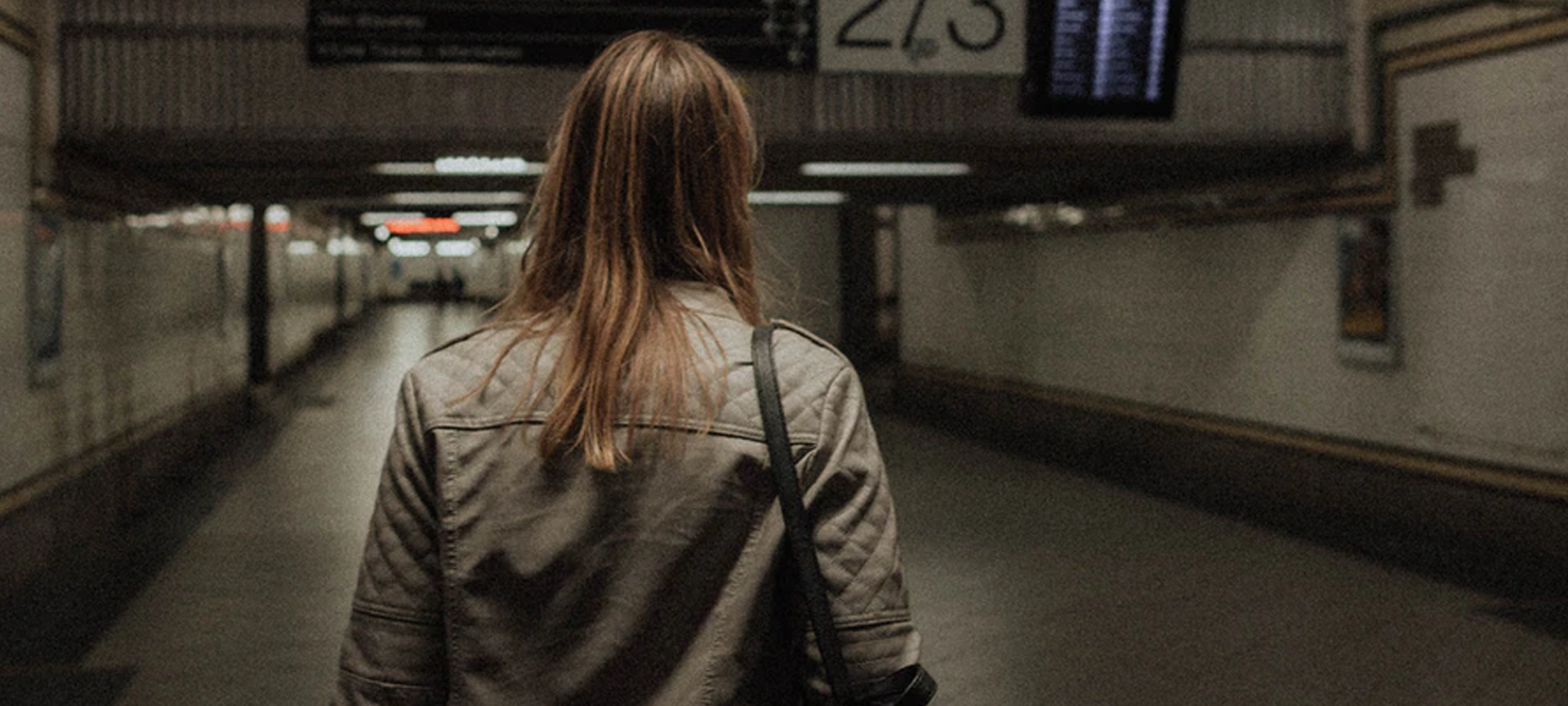 Woman from behind walking in a train station