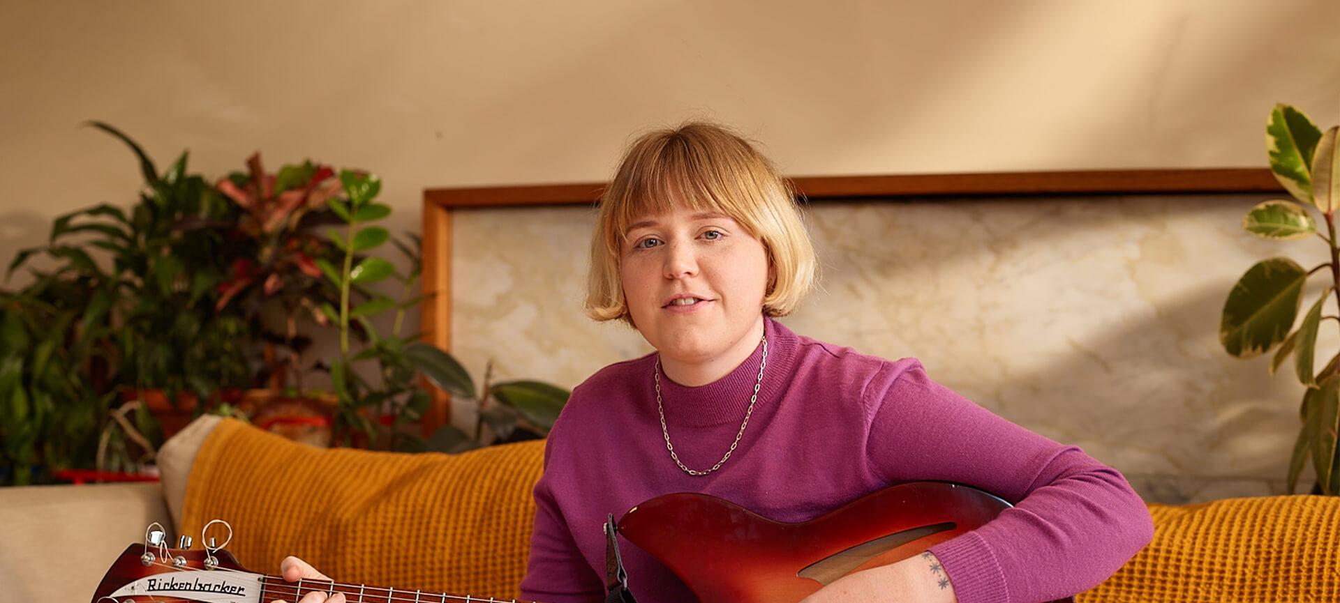 Nellie Jackson at home with her guitar