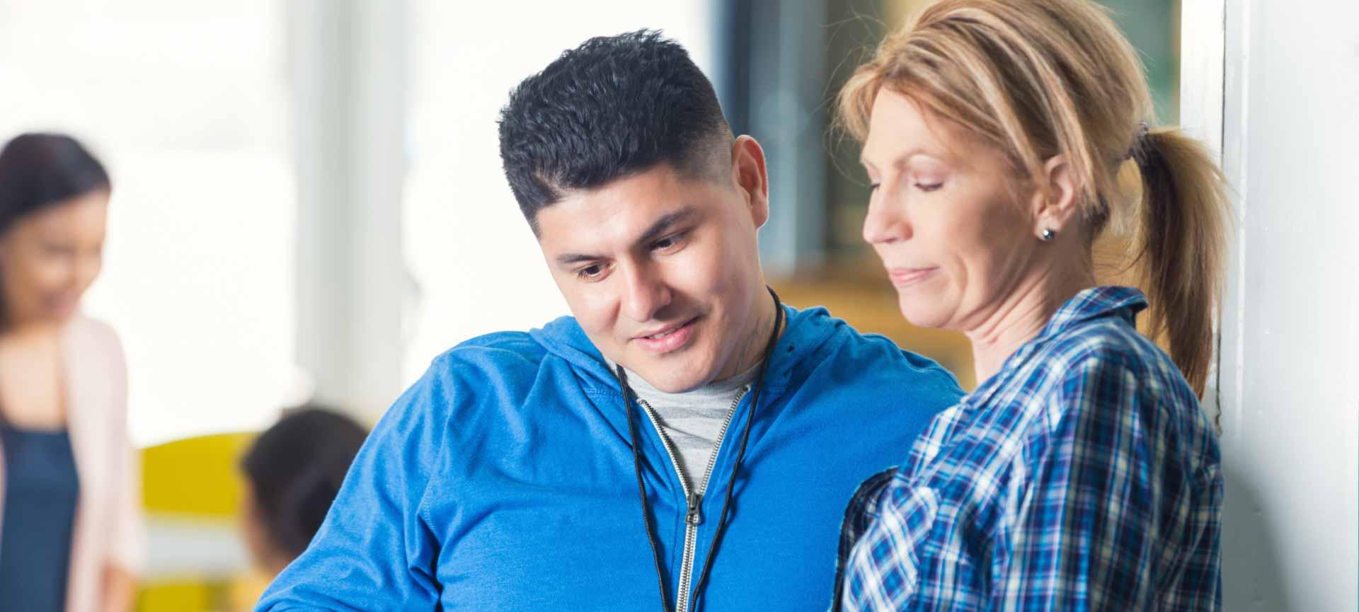 women and man looking at ipad