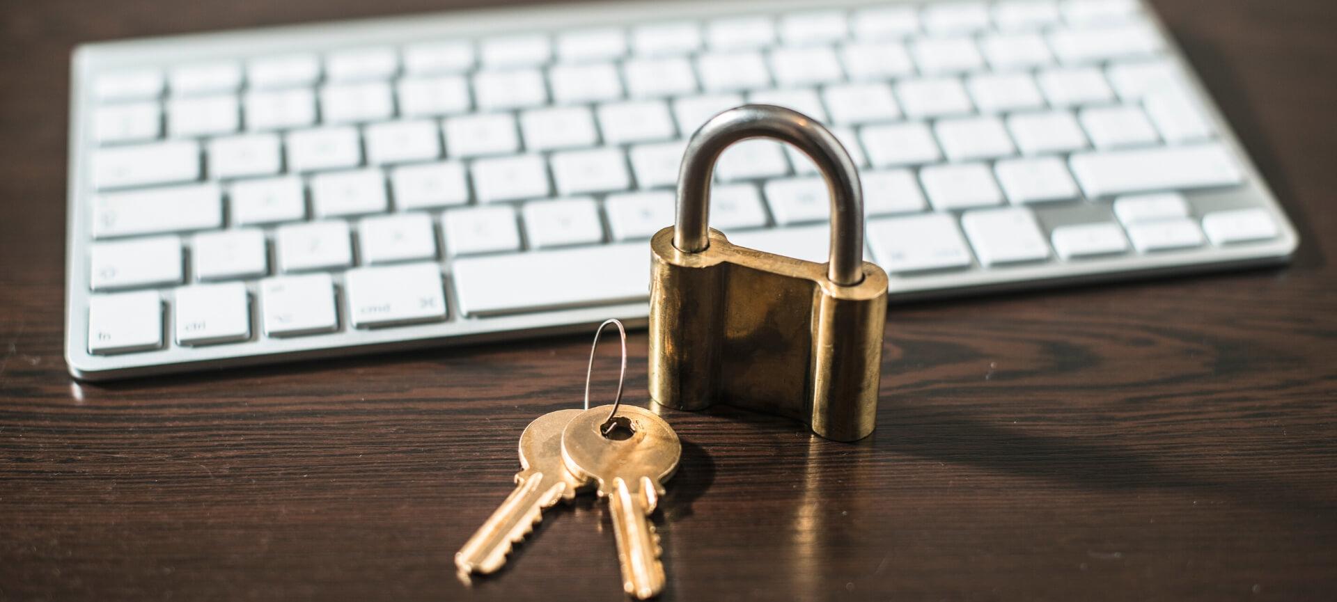 Padlock and key next to keyboard