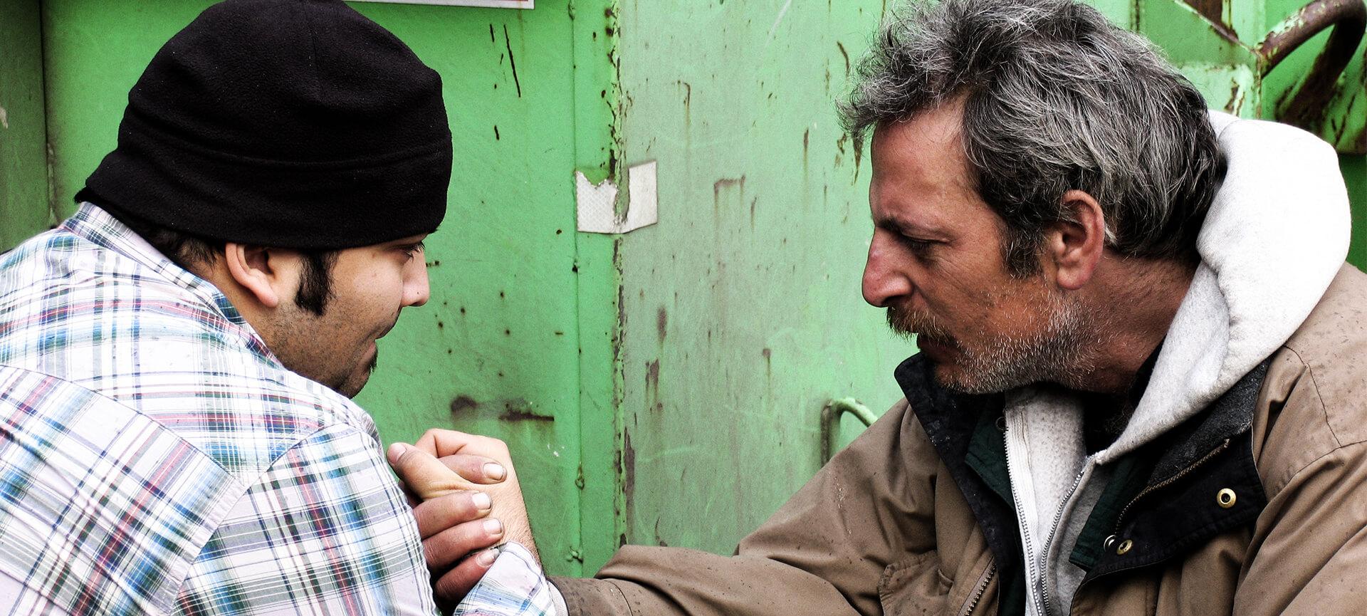 Homelessness worker with man on street