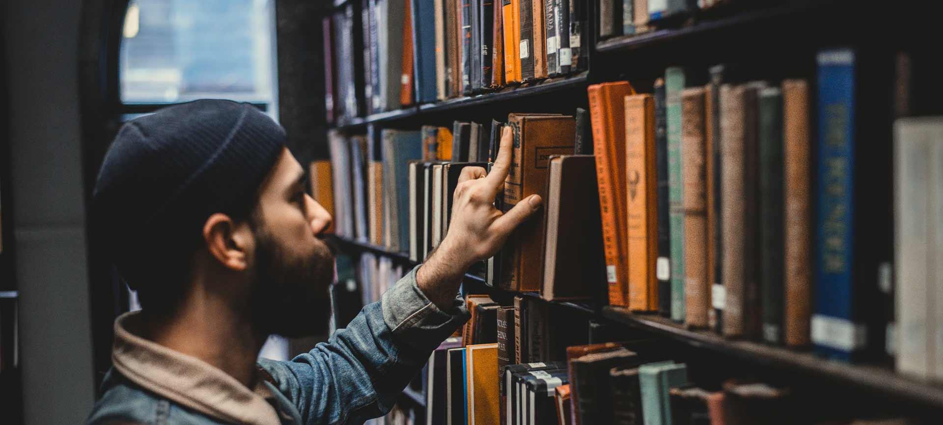 Man selecting book at the library