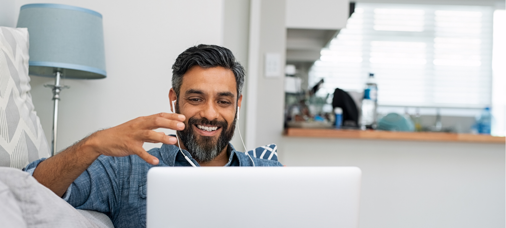 Man at home speaking on a video call on his laptop