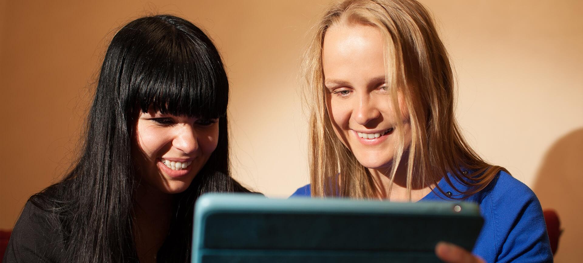 two_women_looking_at_tablet.jpg