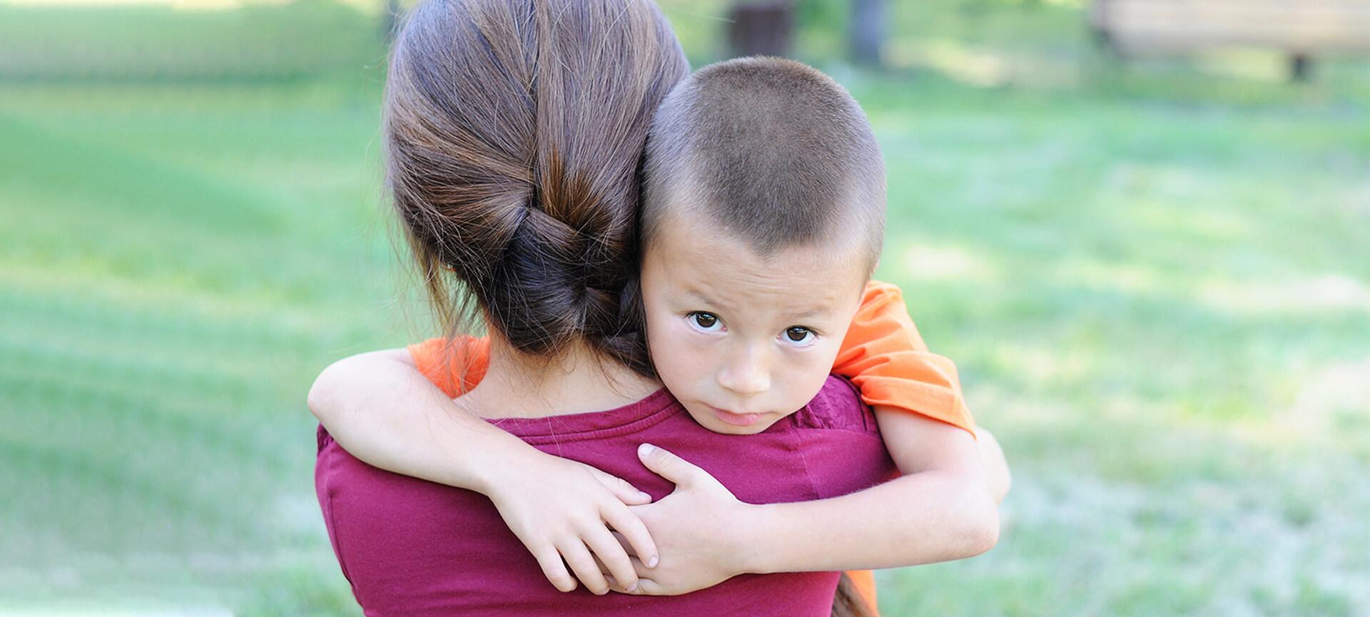 Small boy hugging his mother