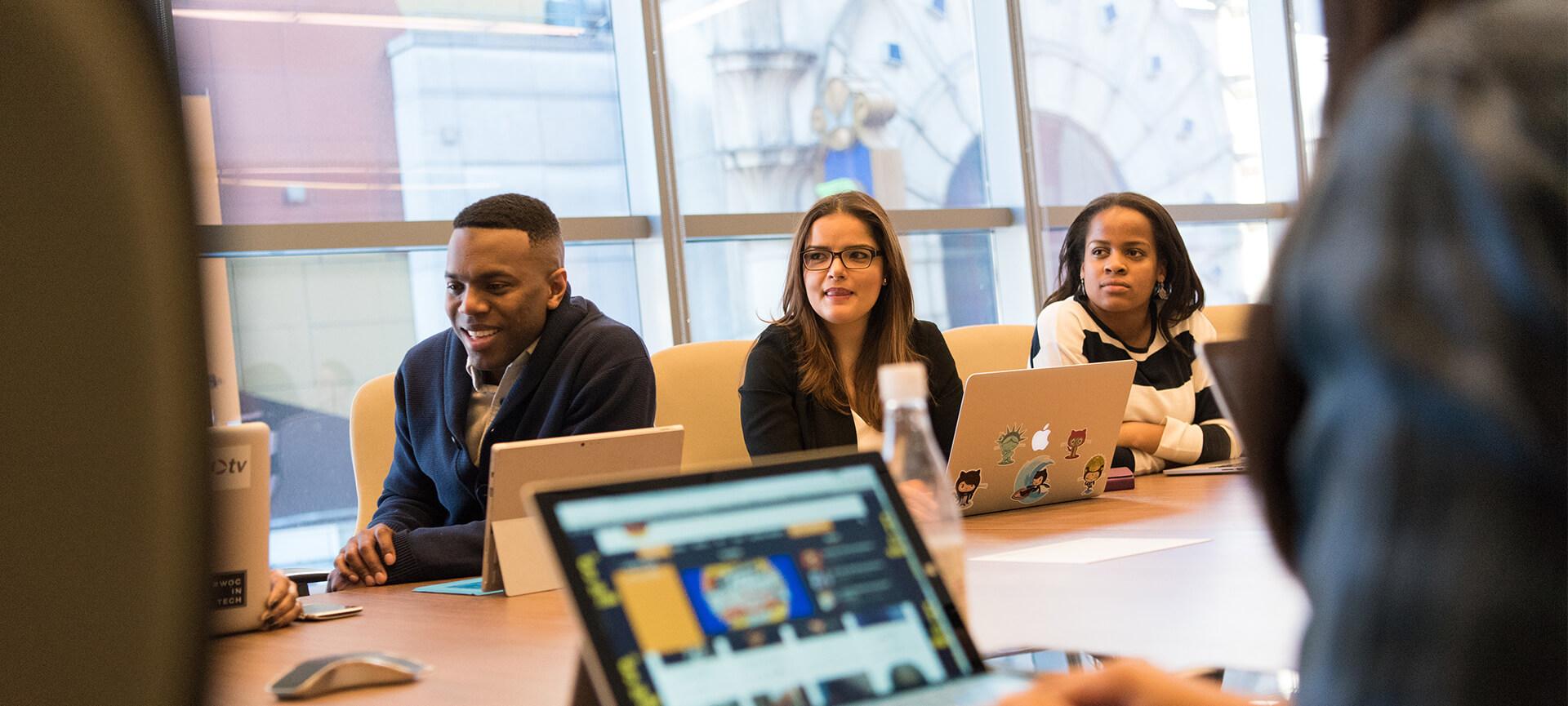 Three people in a computer class