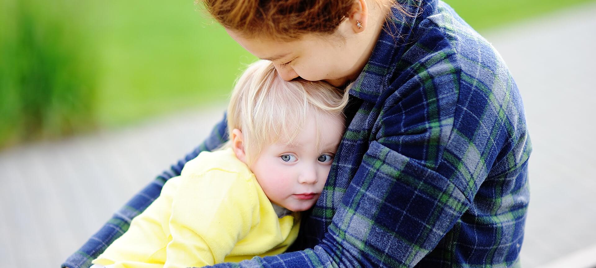 Woman comforting blonde child