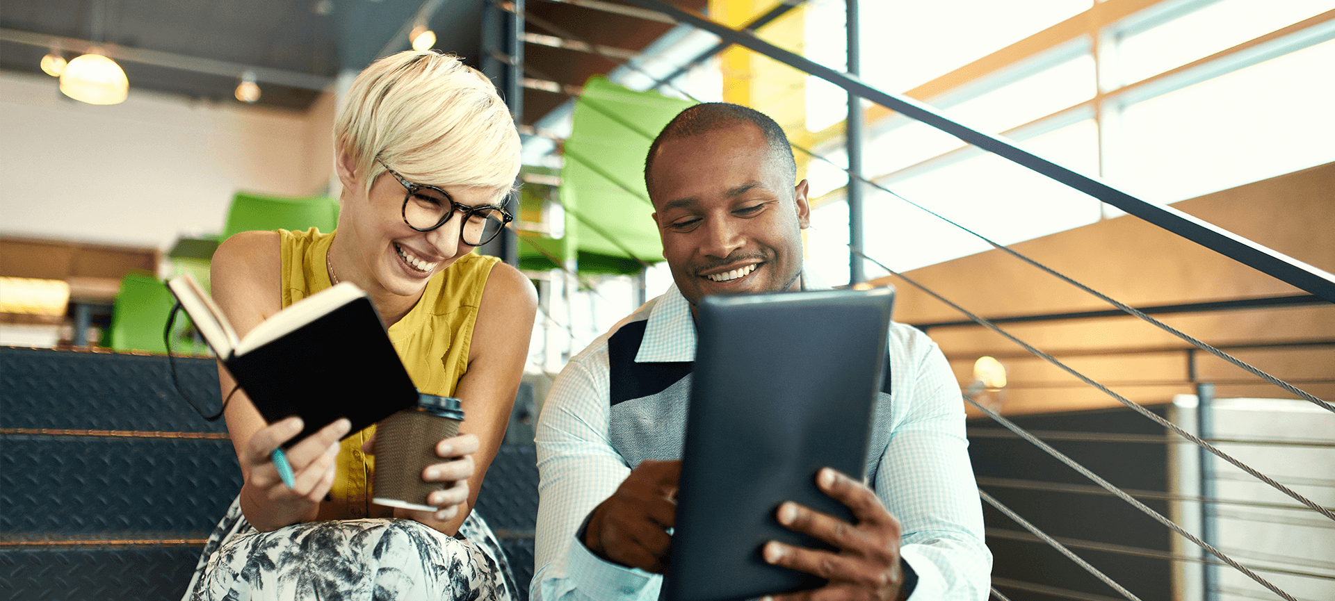 Woman and man professionals looking at tablet