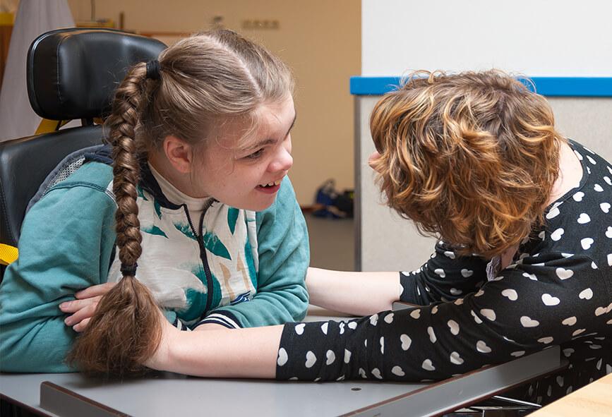 Girl in wheelchair with support worker