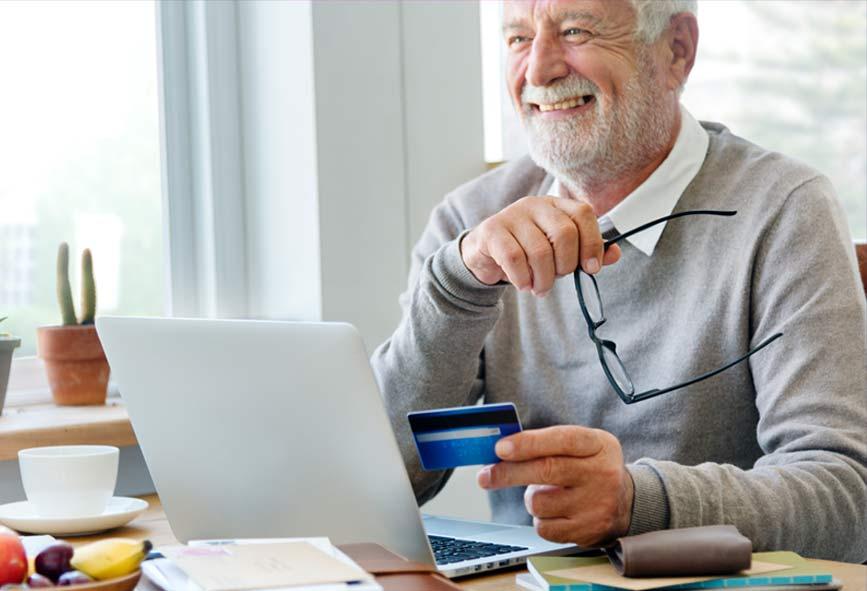 Older man using credit card for online shopping