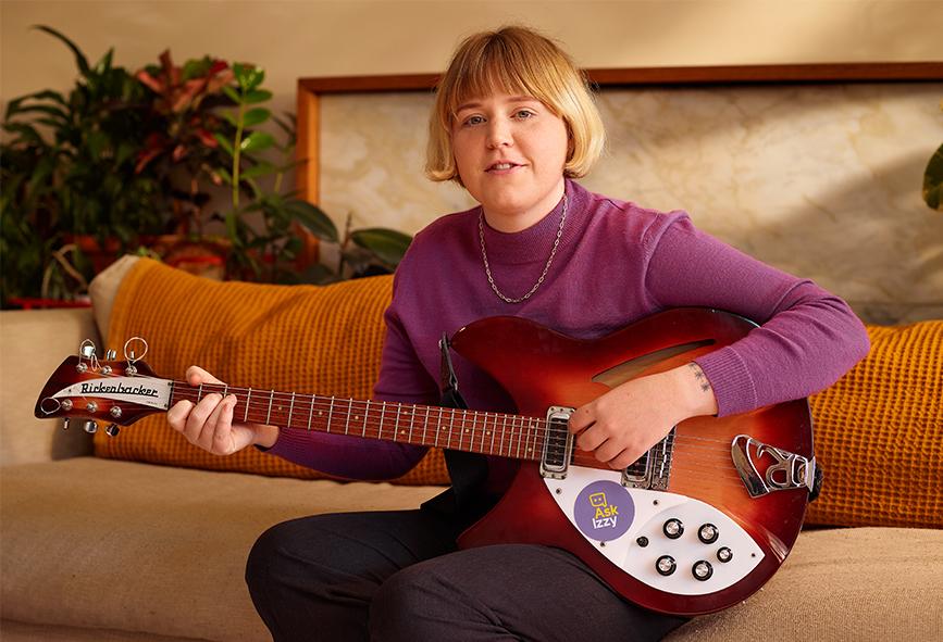 Nellie Jackson at home with her guitar