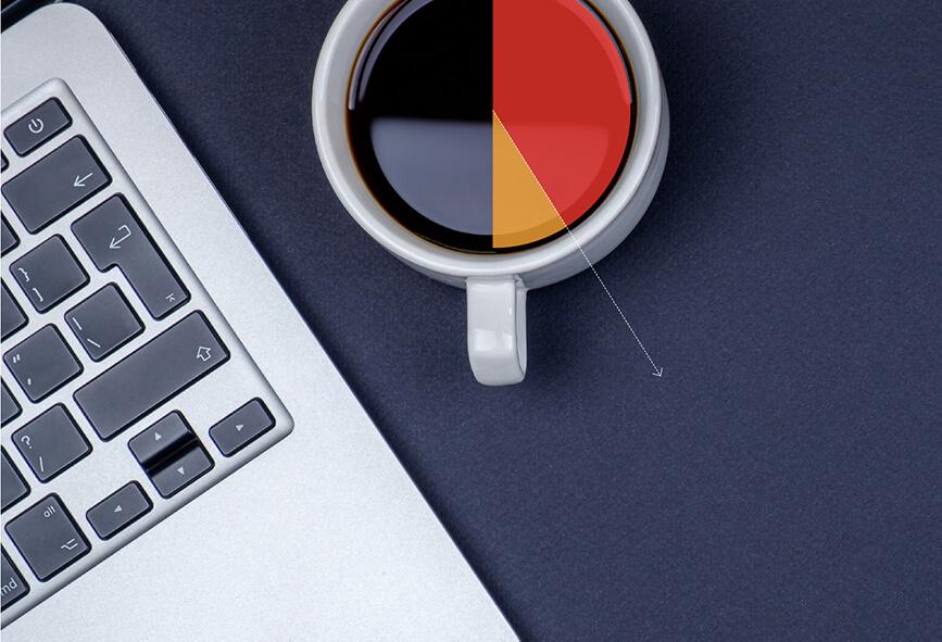 coffee mug and laptop with graph superimposed over the top