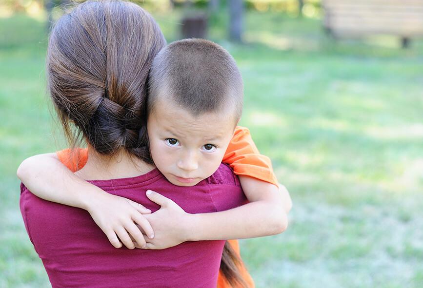 Small boy hugging his mother