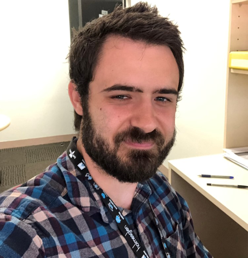 Dan Shaw smiling at the camera wearing a Holmesglen Tafe lanyard