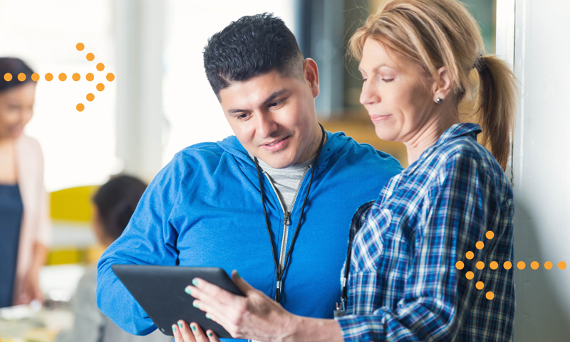 woman and man looking at a tablet