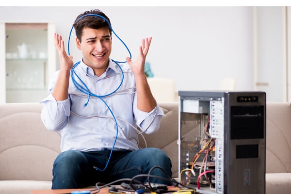 Man frustrated with technology hardware Man frustrated with technology hardware