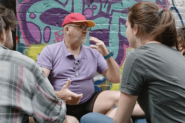 man_talking_to_youth_in_front_of_graffiti.jpg man_talking_to_youth_in_front_of_graffiti.jpg