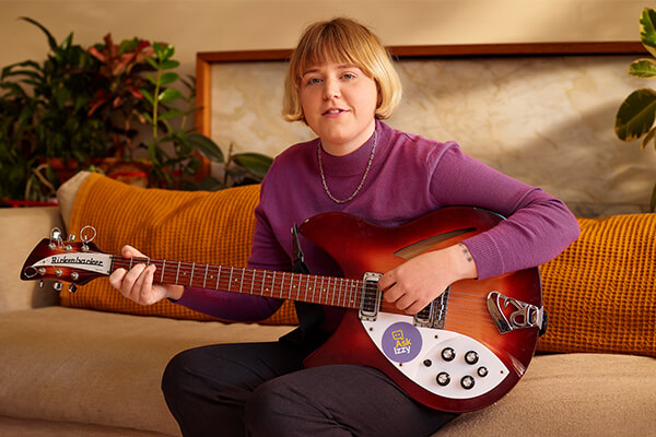 Nellie Jackson at home with her guitar