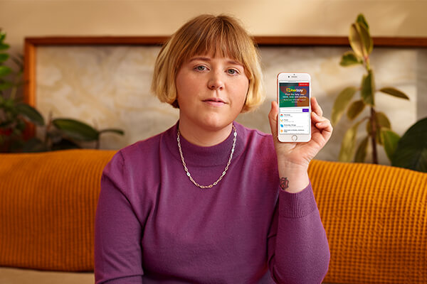 Nellie Jackson holding phone showing Ask Izzy Nellie Jackson holding phone showing Ask Izzy