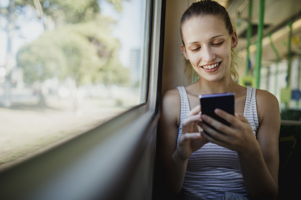 Woman using her phone on a tram in Melbourne